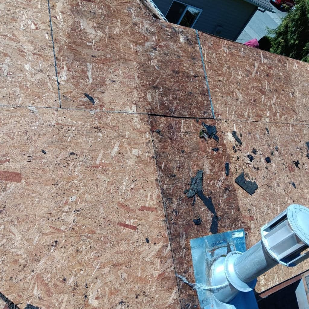 A close up of a roof with a chimney on it.