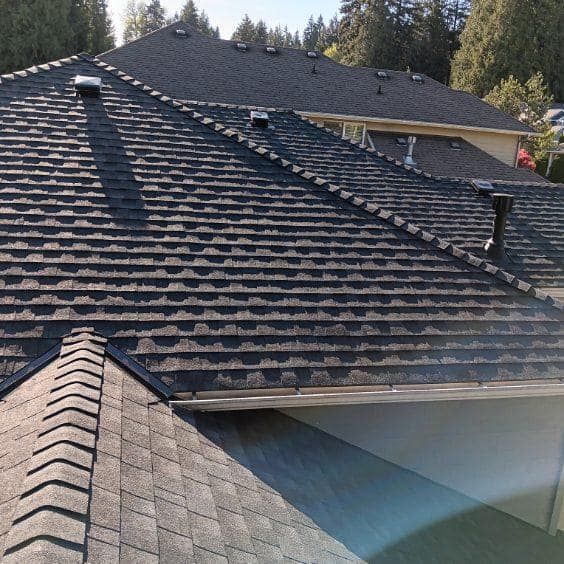 The roof of a house has a lot of shingles on it