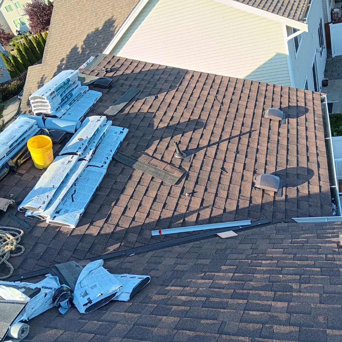 An aerial view of a roof with a yellow bucket on top of it.