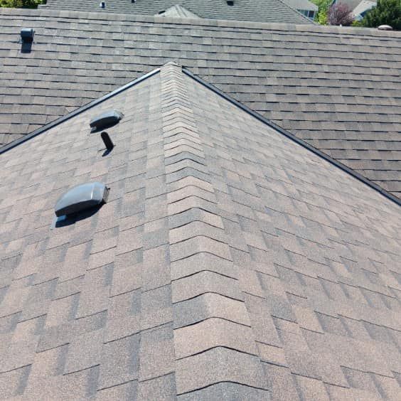 A close up of a roof with a few vents on it