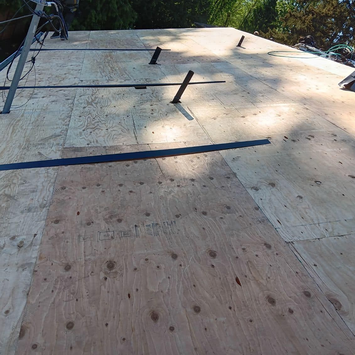 A wooden roof with a ladder on top of it.