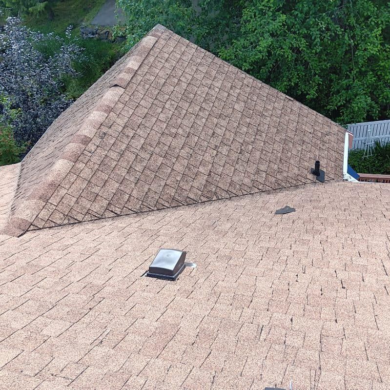 A pyramid shaped roof with a skylight on top of it.