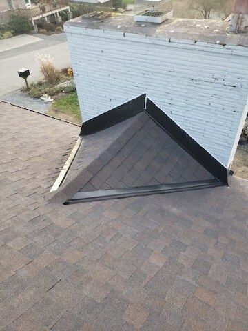 An aerial view of a roof with a chimney on top of it.