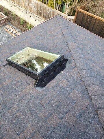 There is a skylight on the roof of a house.