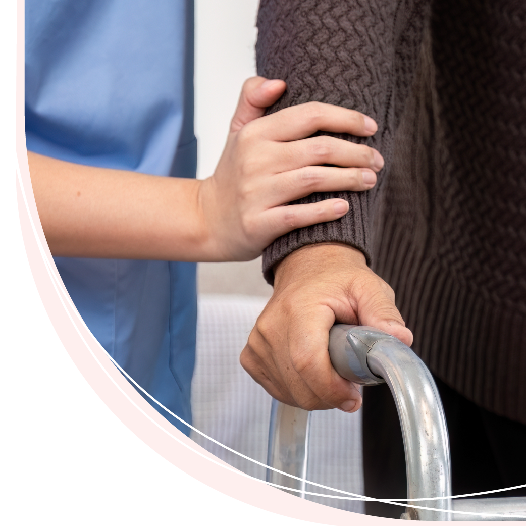 A nurse is helping an elderly woman use a walker