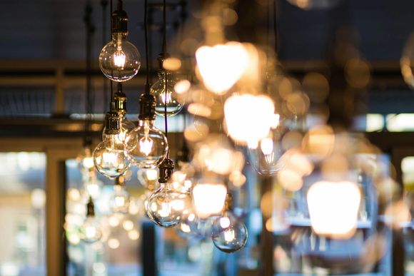 String of glowing, clear light bulbs hanging from ceiling; soft, warm light.