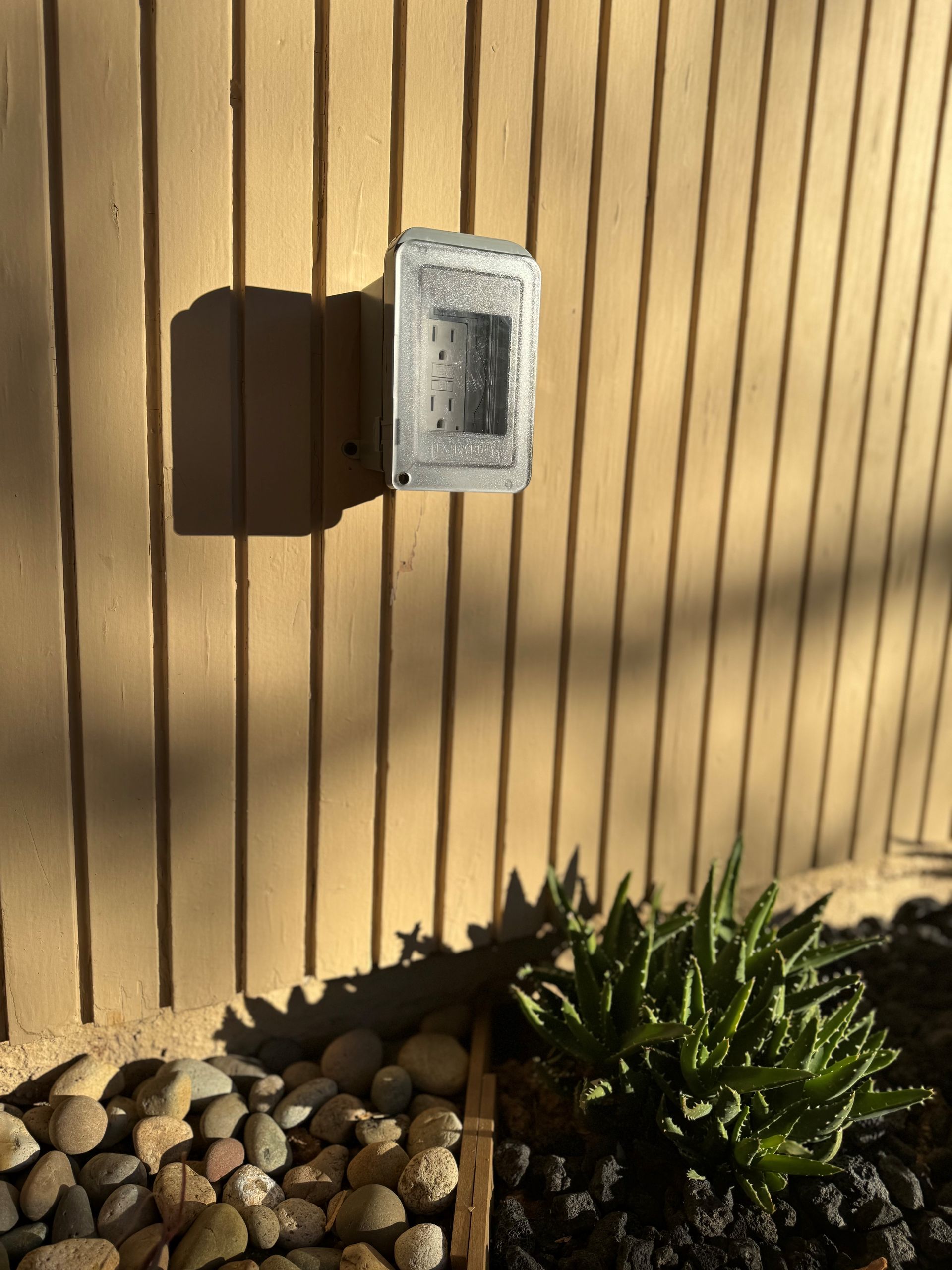 A light switch on the side of a building