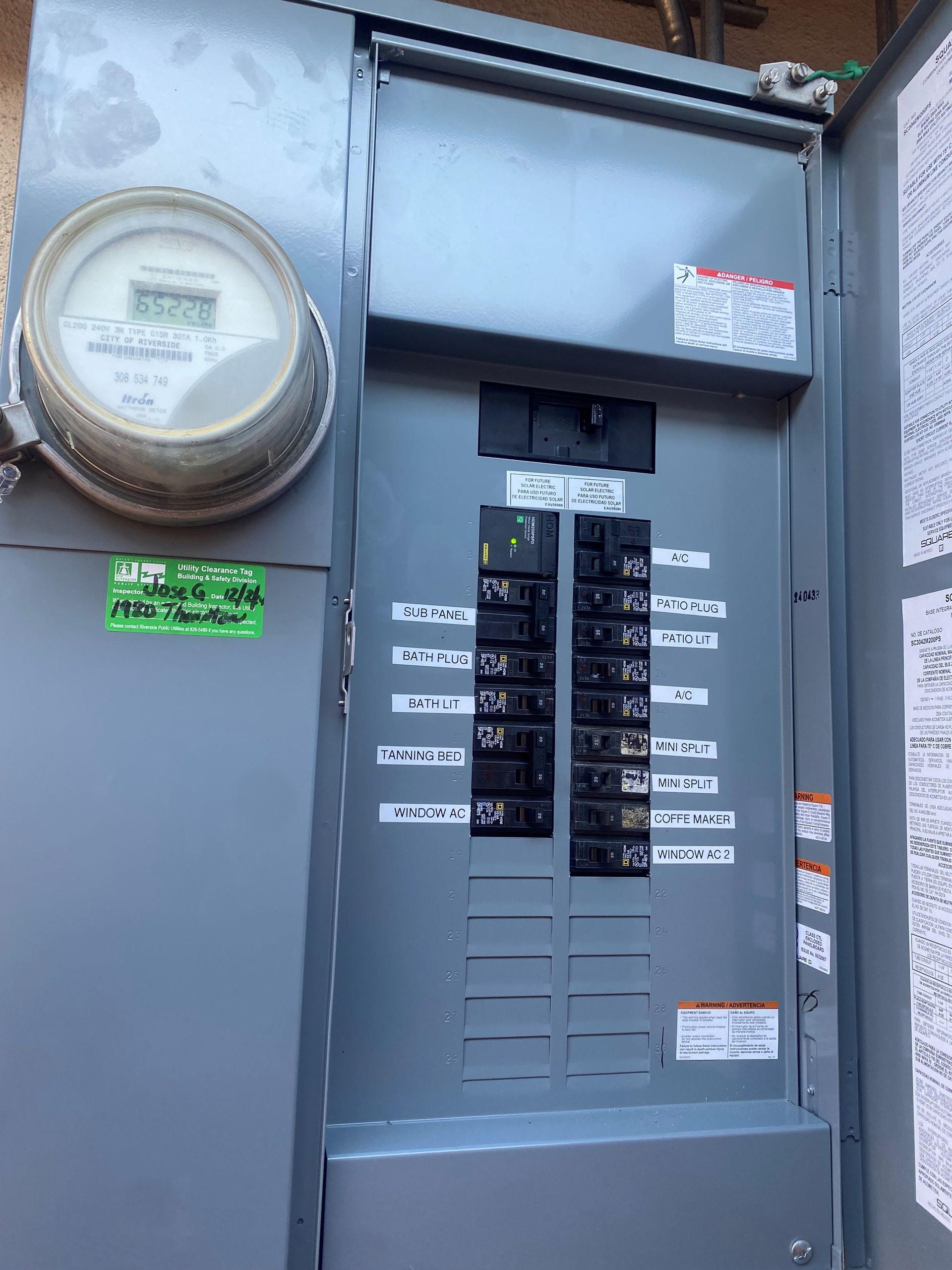 An electrician is holding a light bulb in his hands.