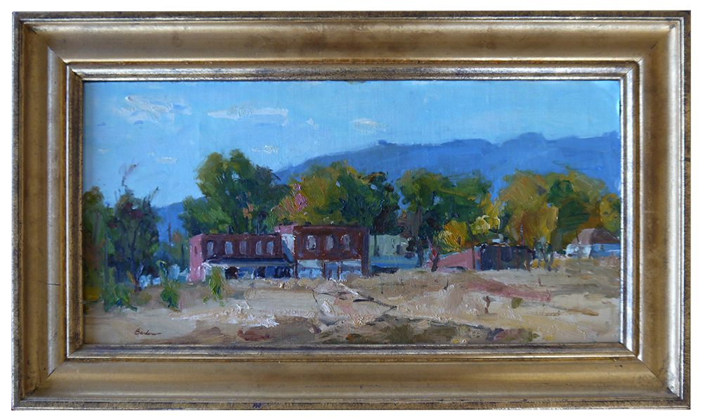 A framed painting of a landscape with mountains in the background