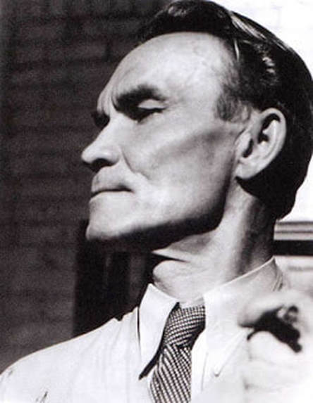 A black and white photo of a man wearing a shirt and tie