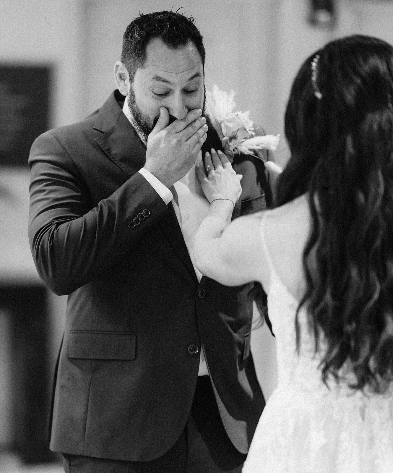 A black and white photo of a bride and groom dancing