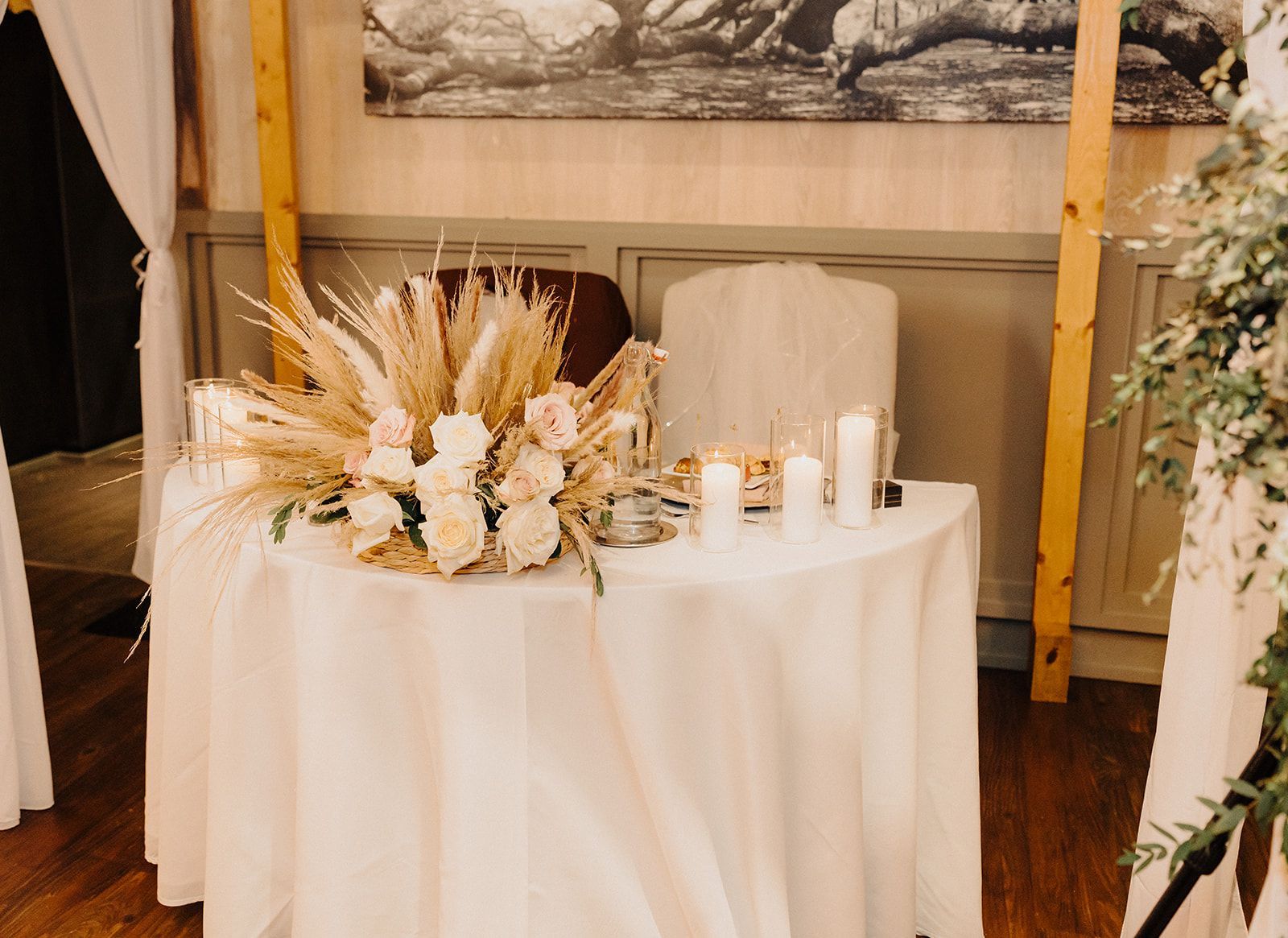 A table with flowers and candles on it in a room.