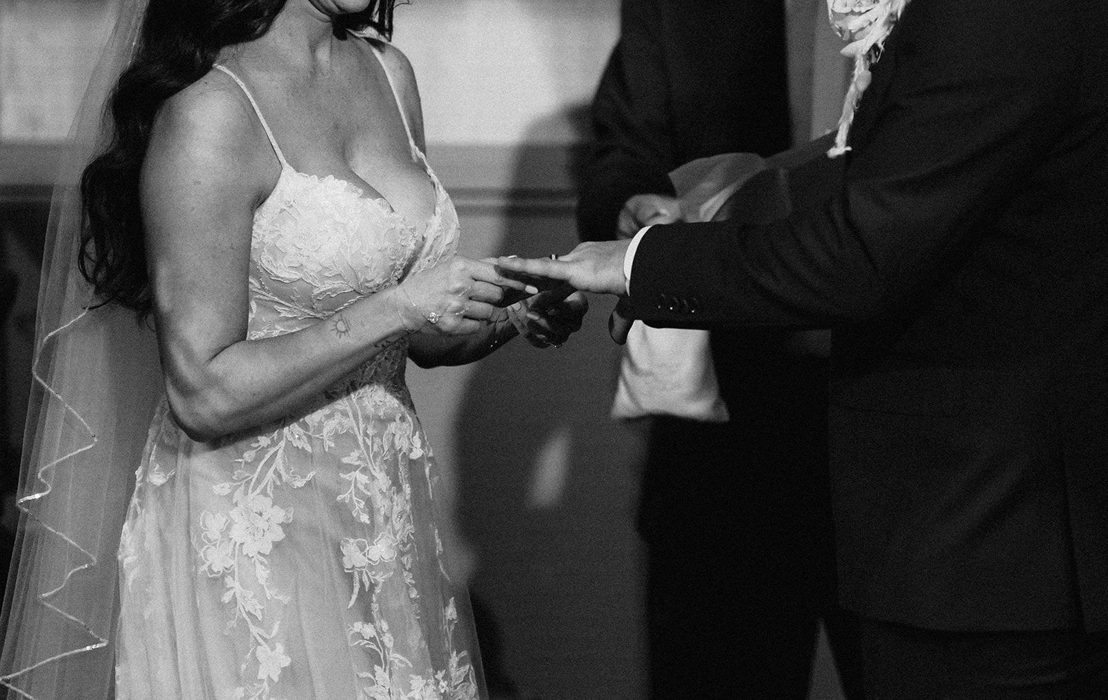 A bride and groom are getting married in a black and white photo.