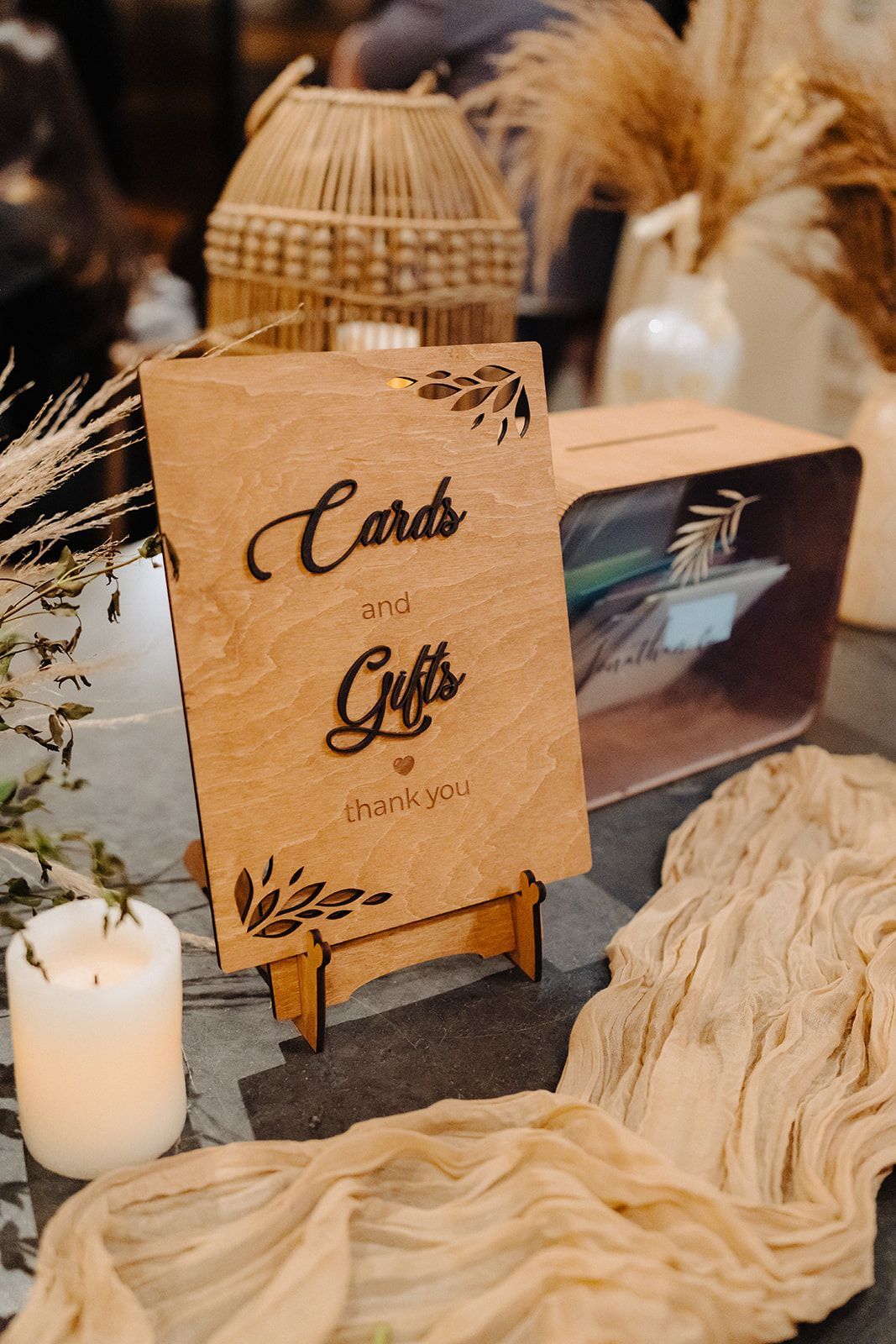 A wooden sign that says `` cards and gifts '' is sitting on a table.