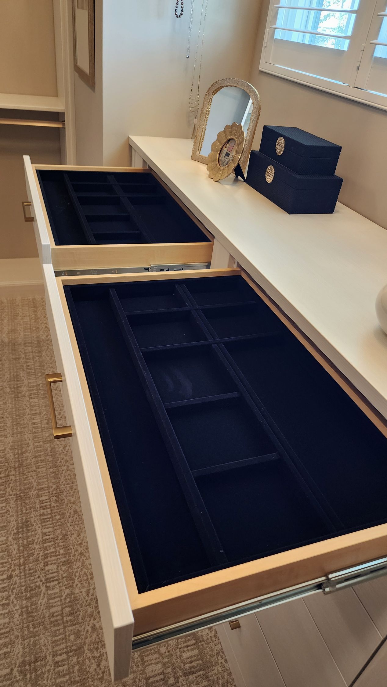 A dresser with two drawers open and a mirror on top of it.