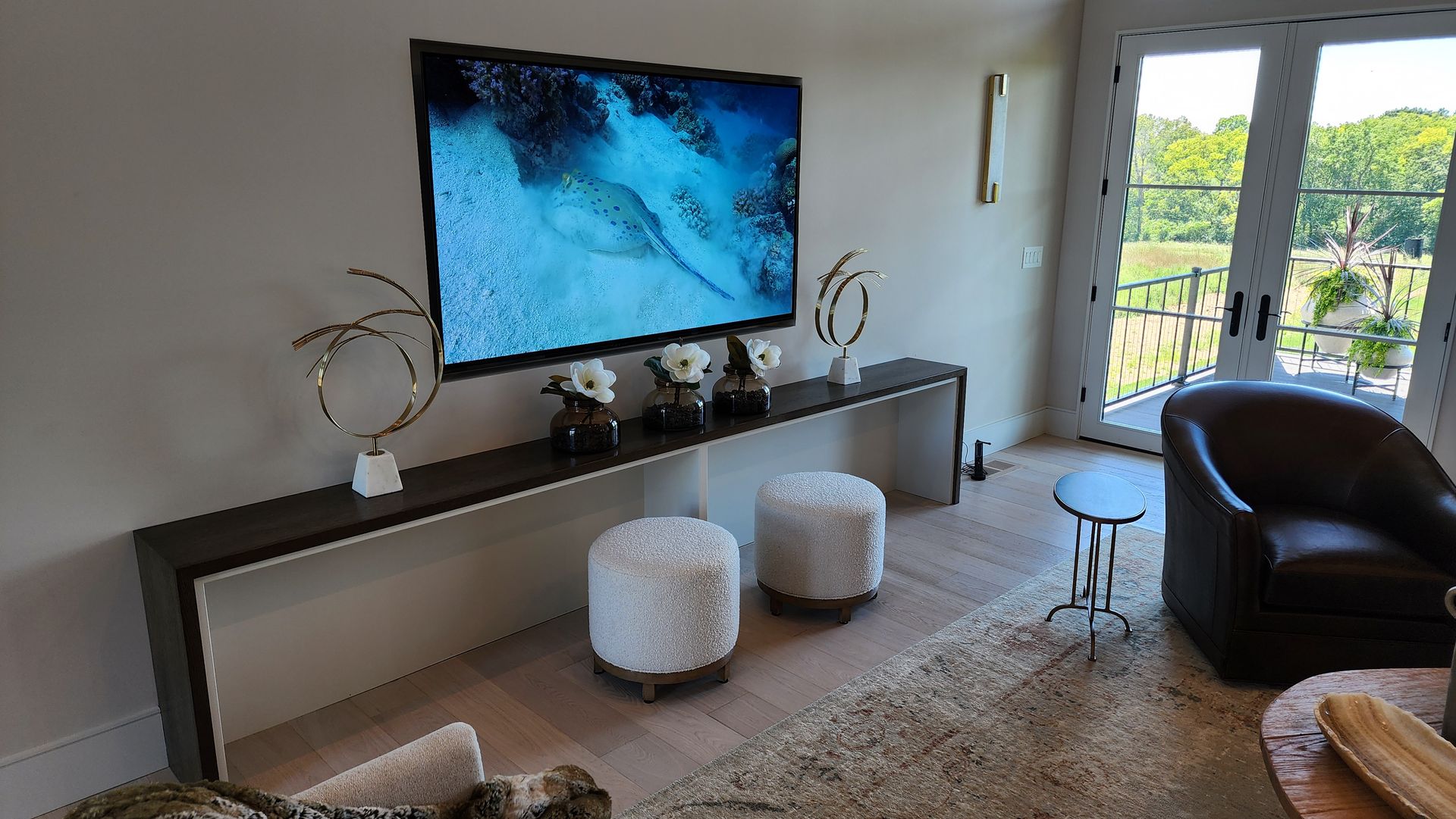 A living room with a large flat screen tv mounted on the wall.