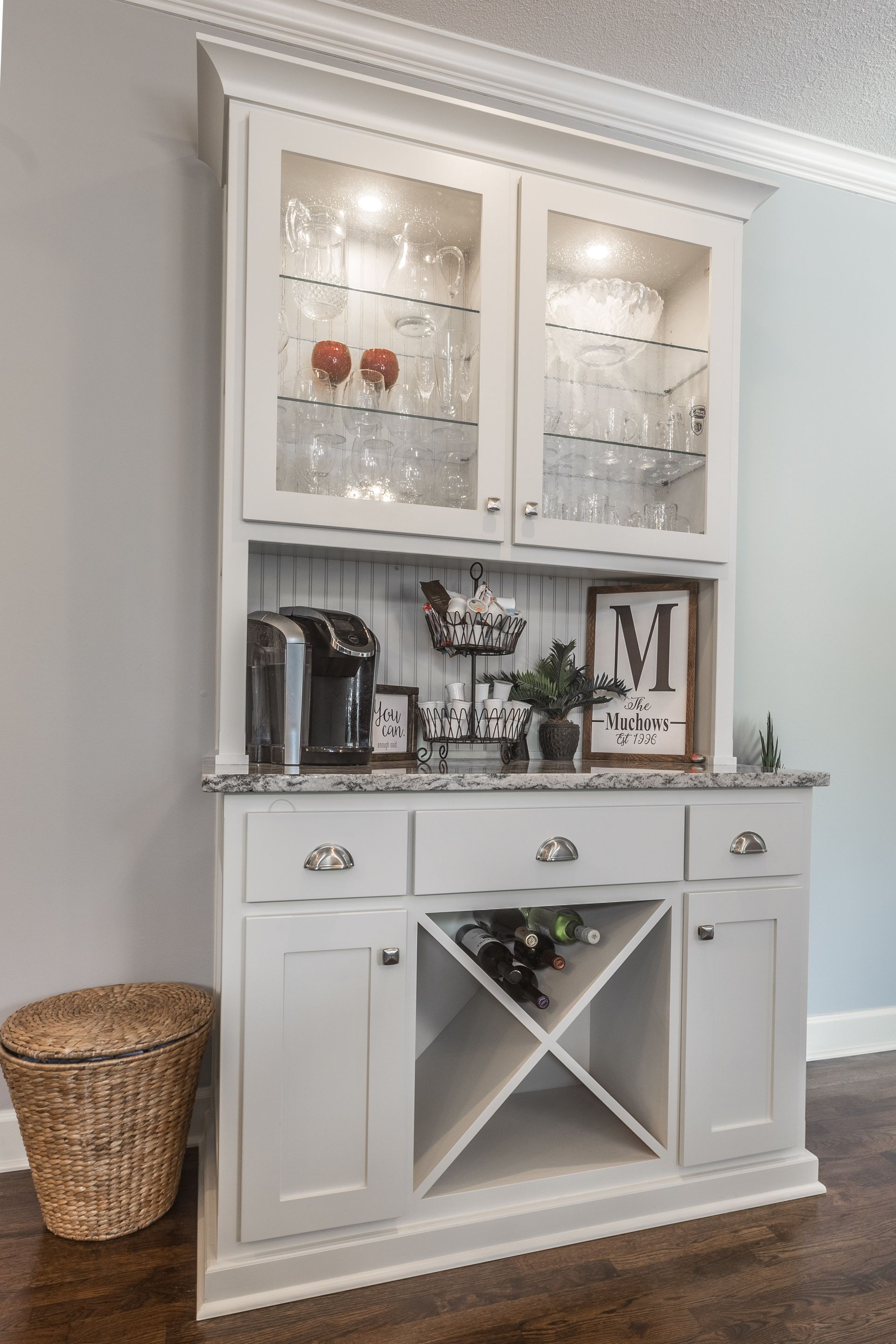 There is a wine rack in the middle of the cabinet.