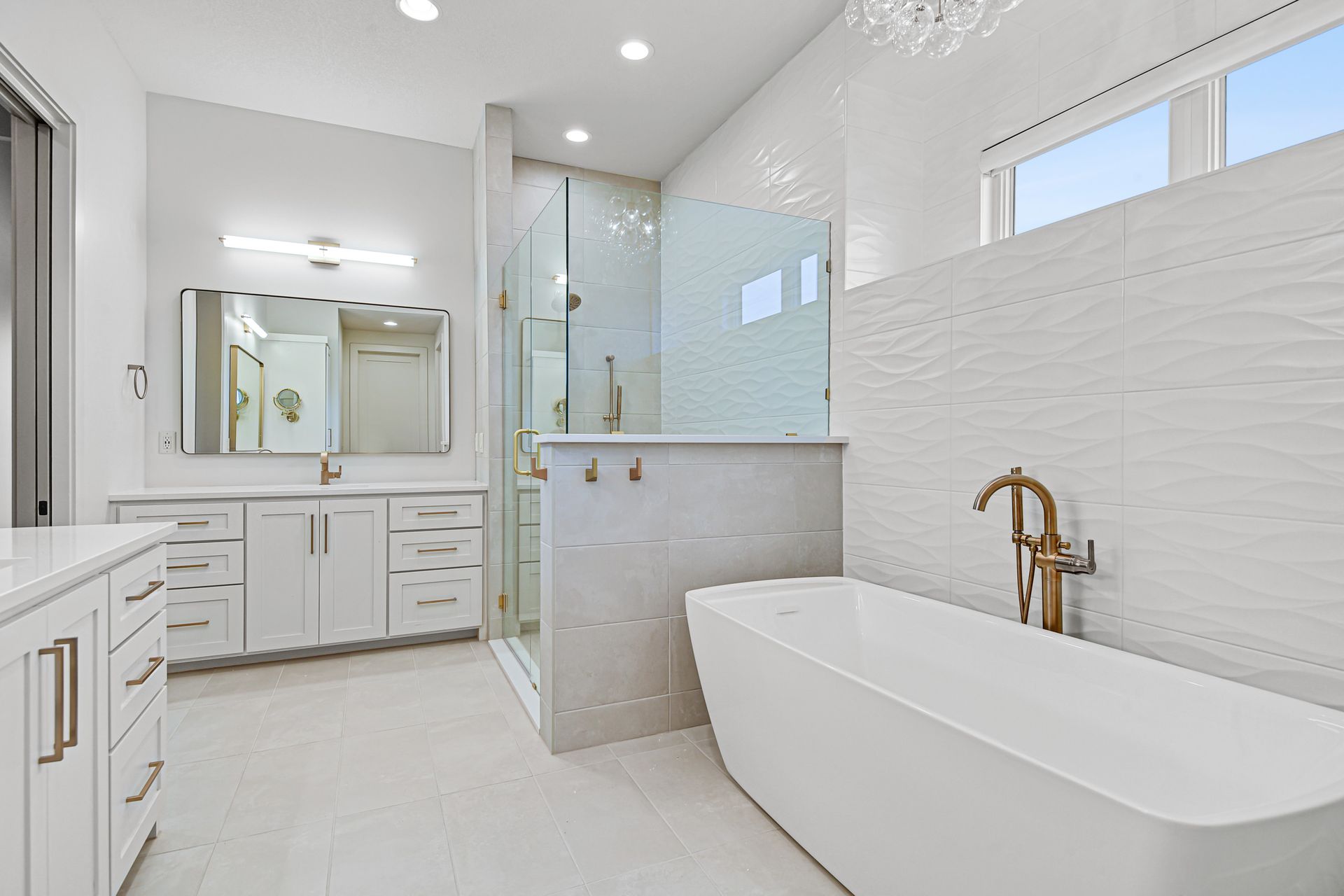 A bathroom with a bathtub and a walk in shower.