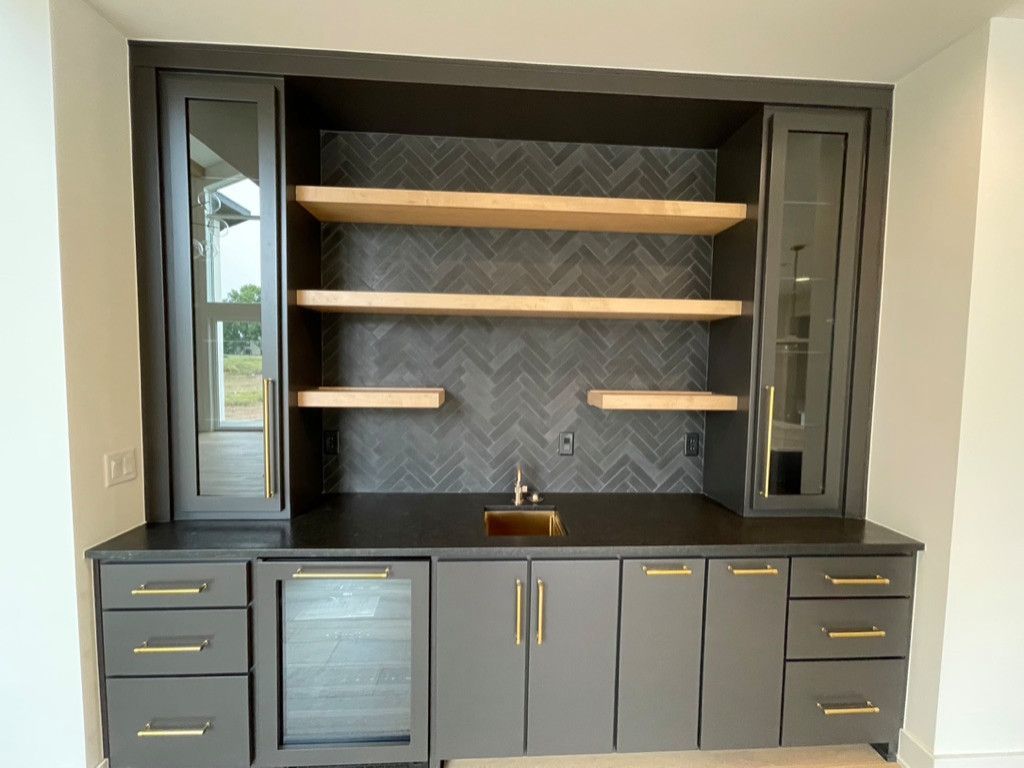 A kitchen with lots of cabinets and shelves and a sink