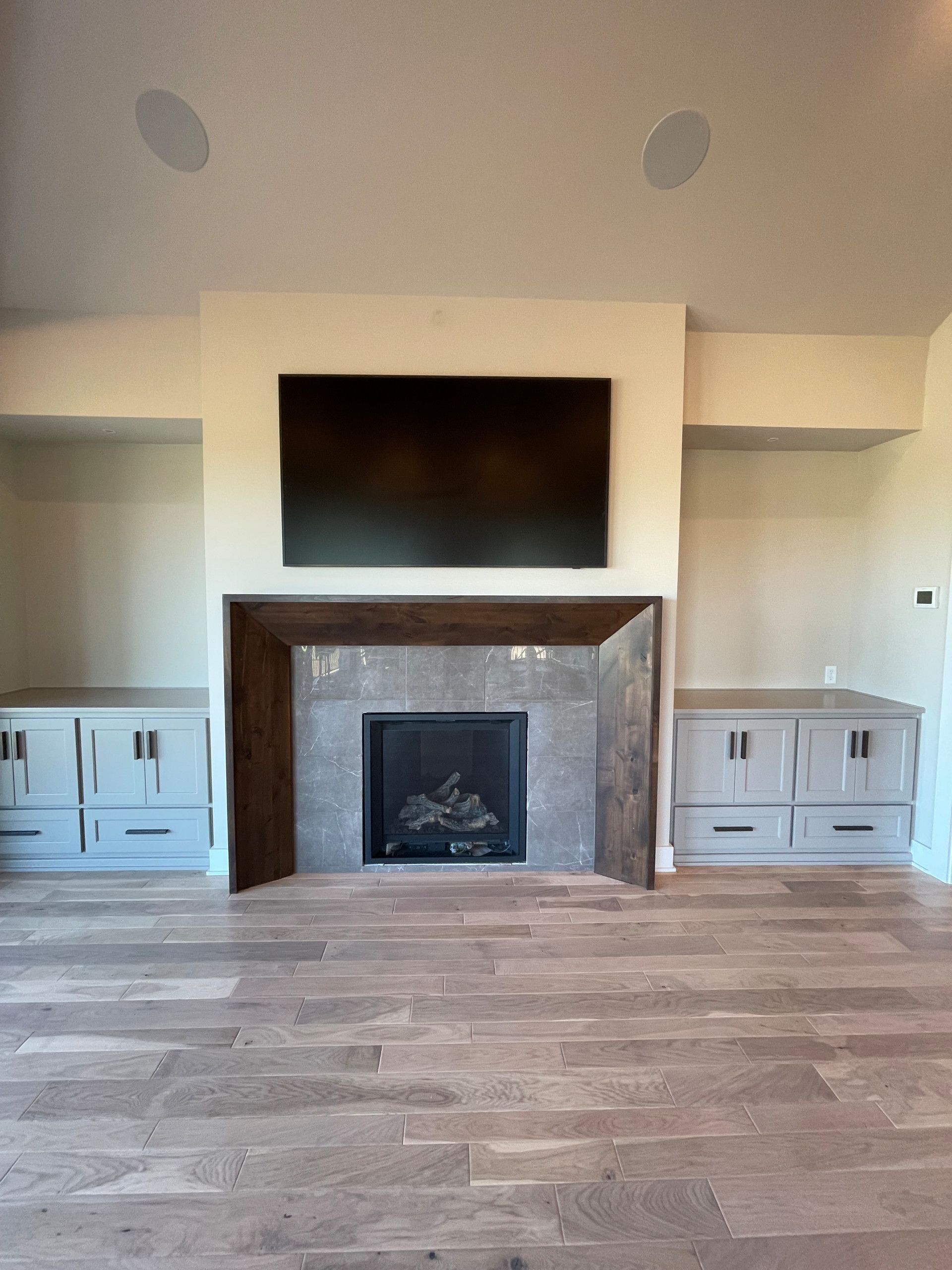 A living room with a fireplace and a flat screen tv