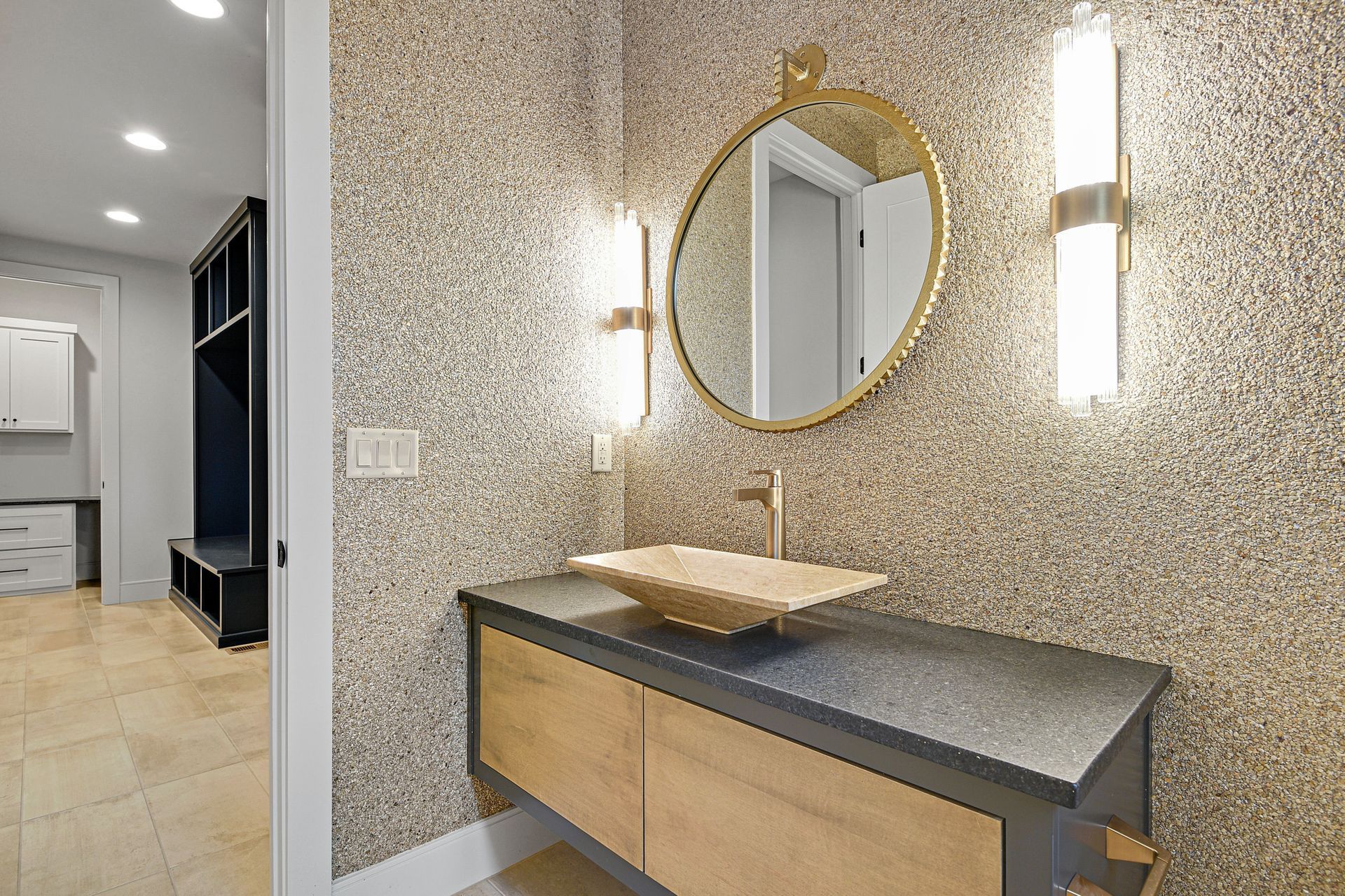 A bathroom with a sink and a mirror on the wall.