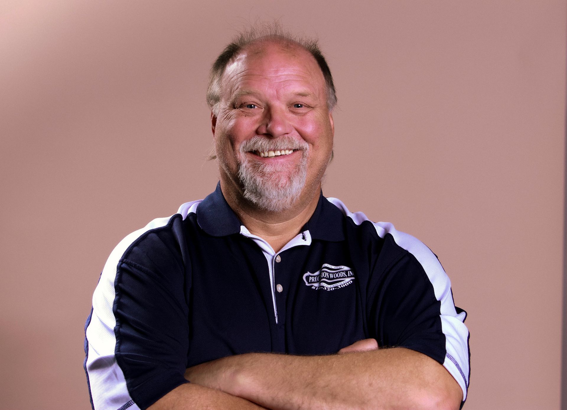 A man with his arms crossed is wearing a shirt that says ' gators ' on it