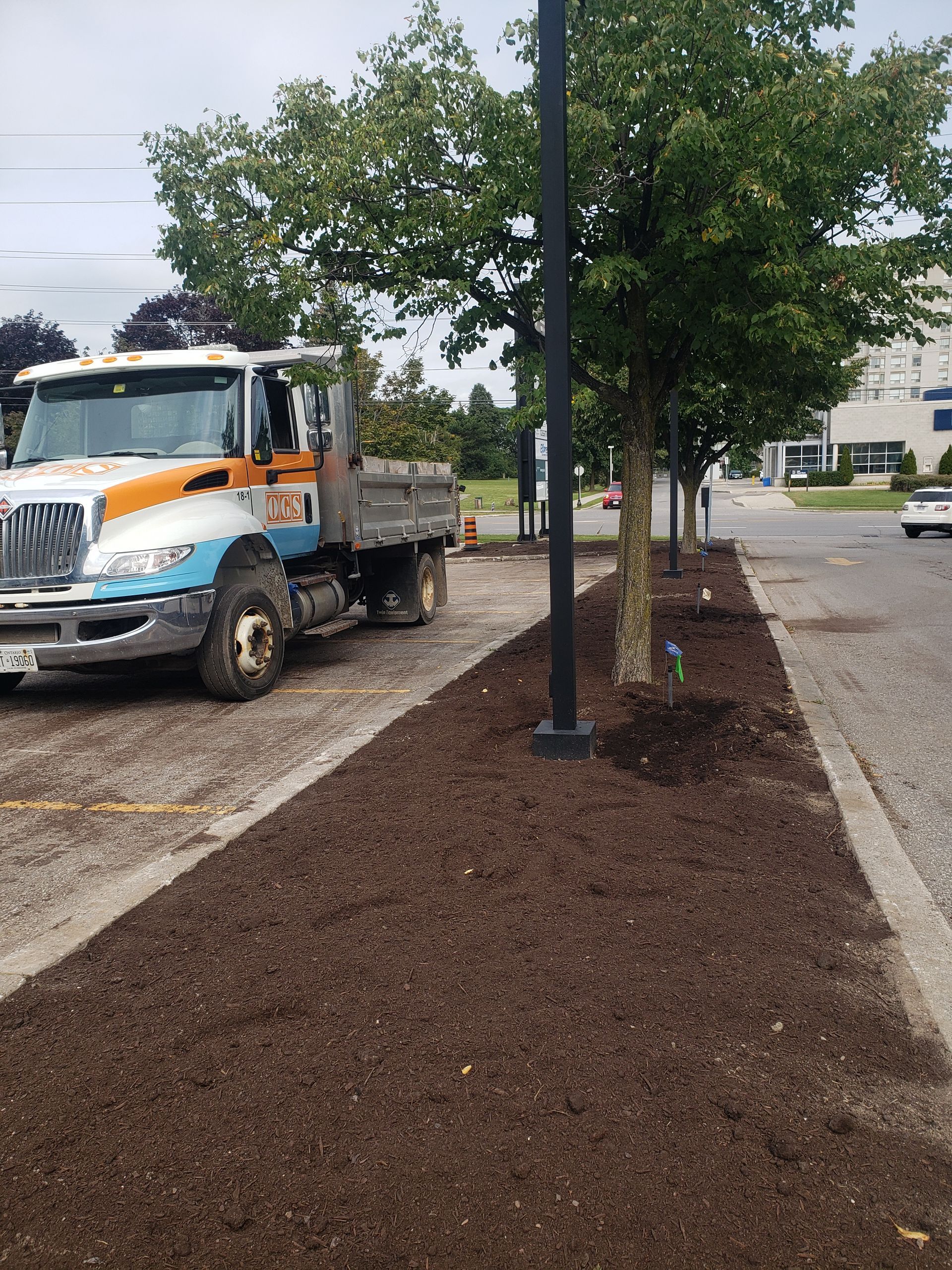 OGS truck in front of large commercial mulch job