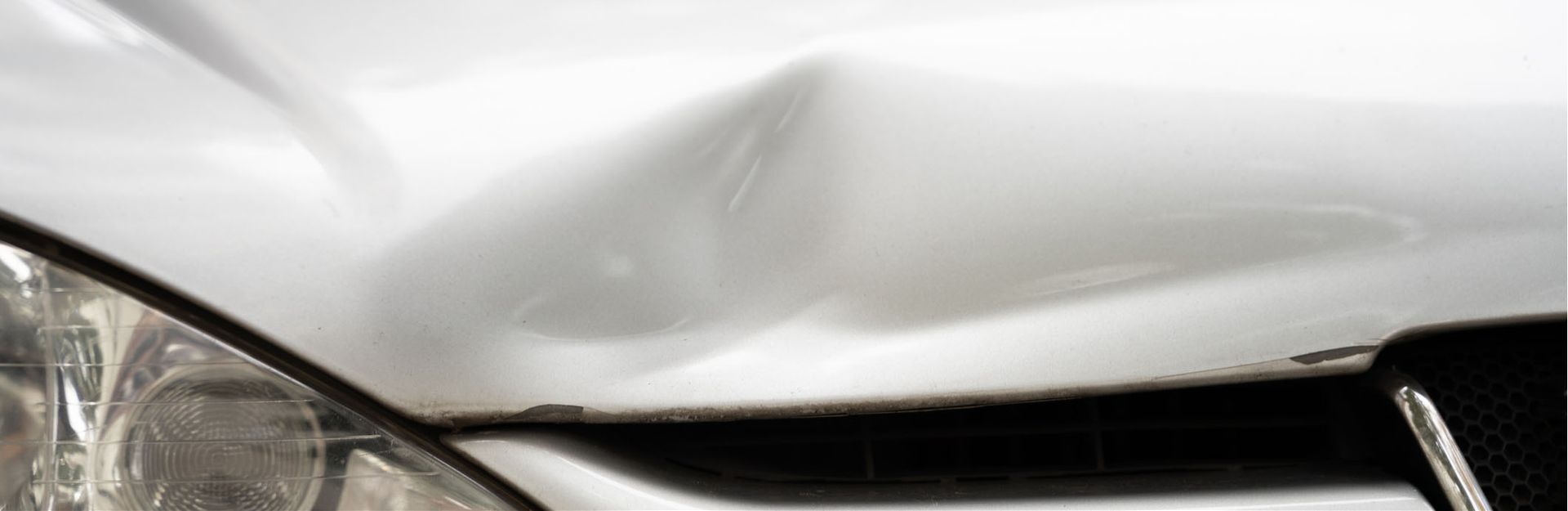 A close up of a car with a damaged bumper.