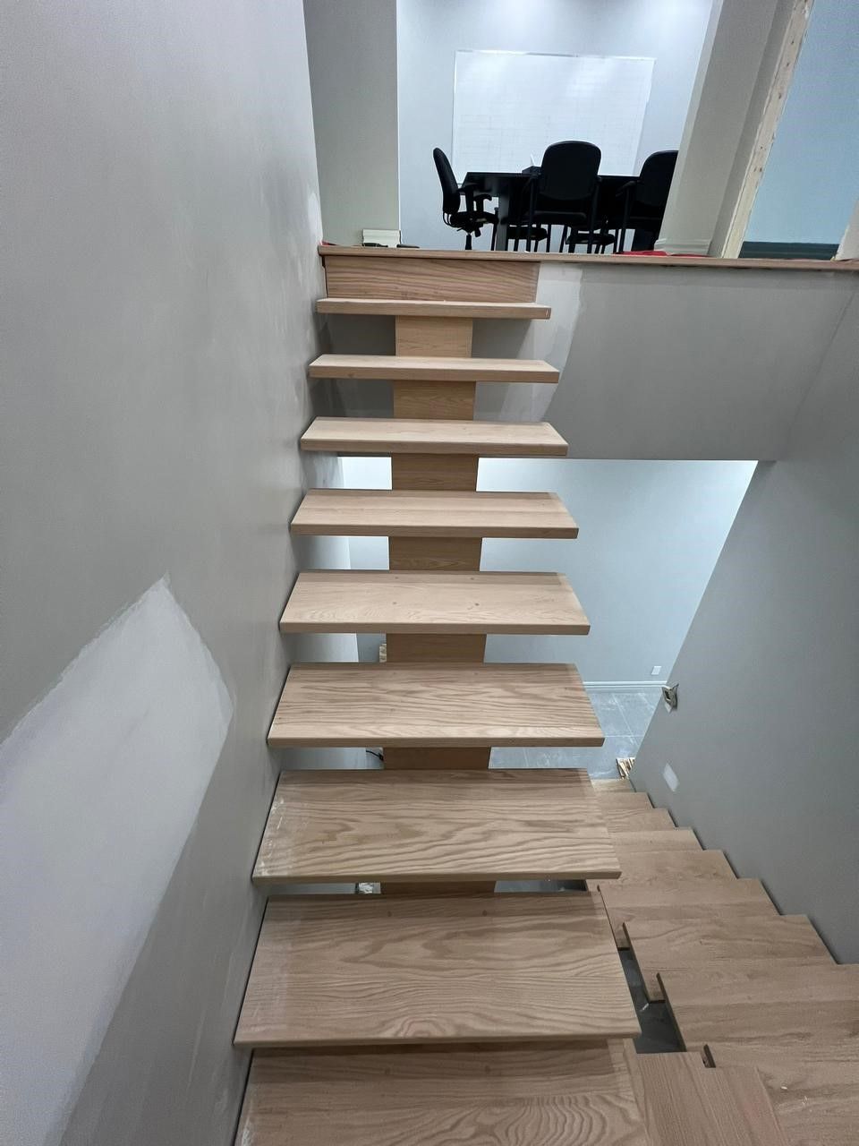 A wooden staircase leading up to the second floor of a house.