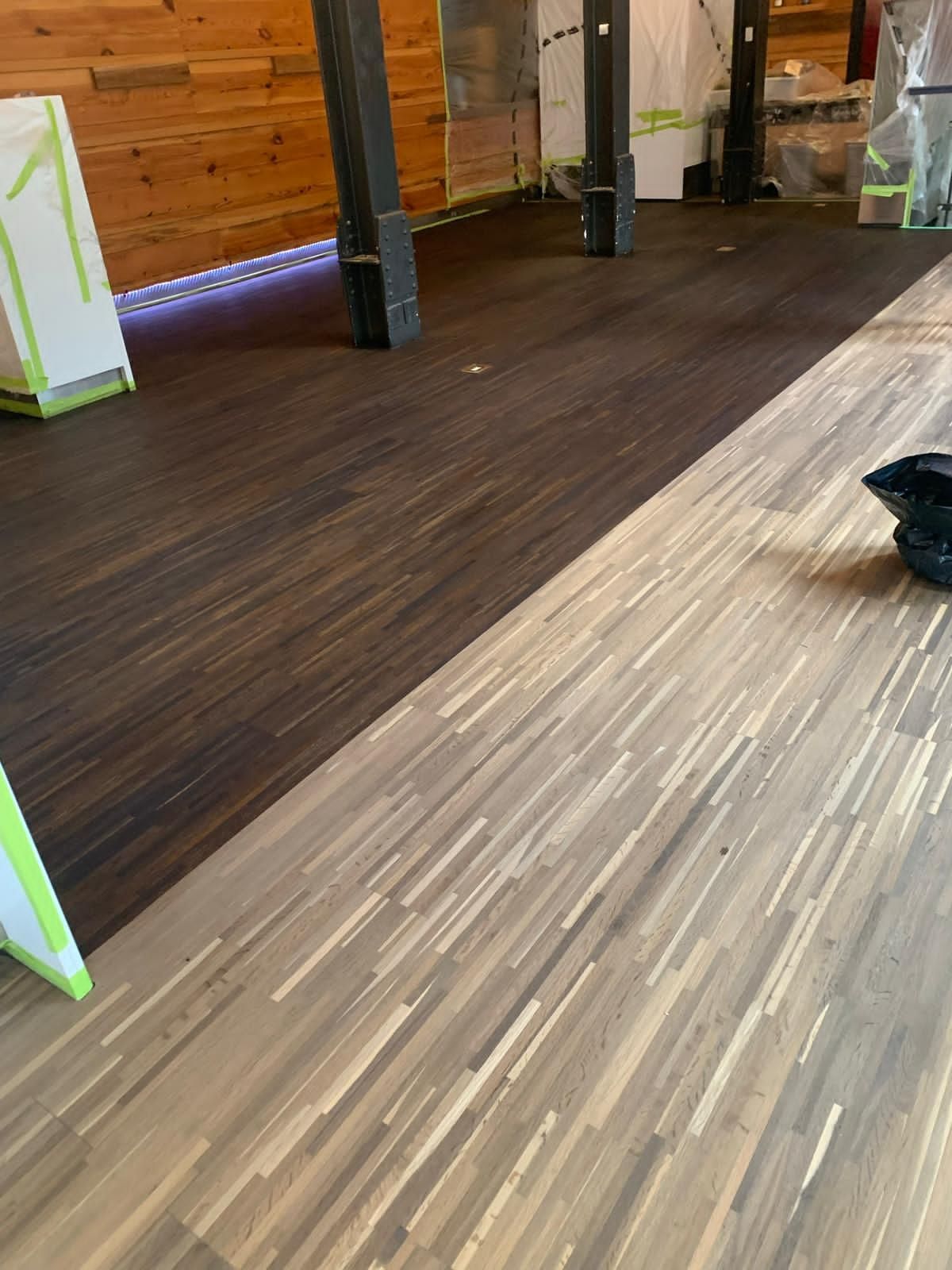 a wooden floor is being installed in a room .