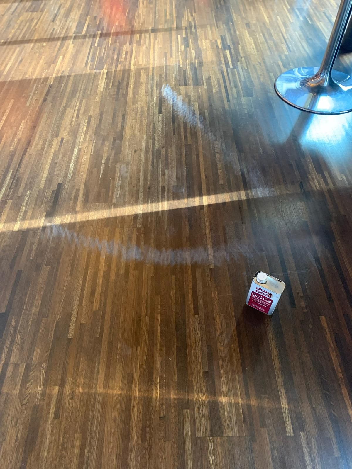 a box of popcorn is sitting on a wooden floor .