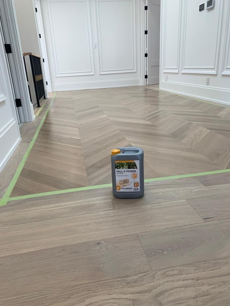 a bottle of scotch oil sits on a hardwood floor