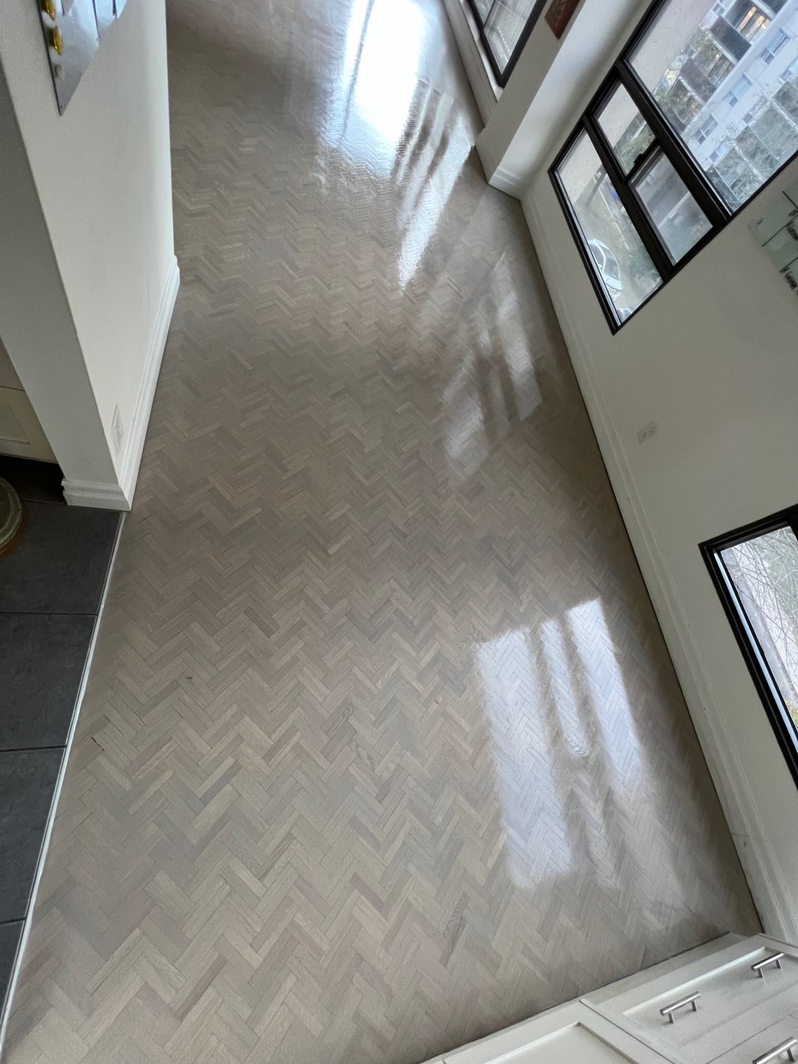 A room with a wooden floor and a lot of windows.