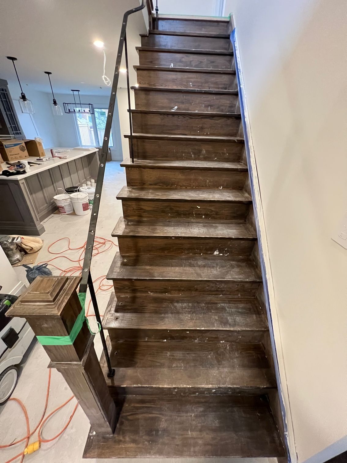 A wooden staircase is being built in a house.