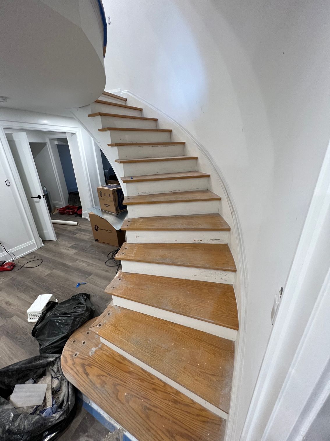 A spiral staircase is being built in a house.