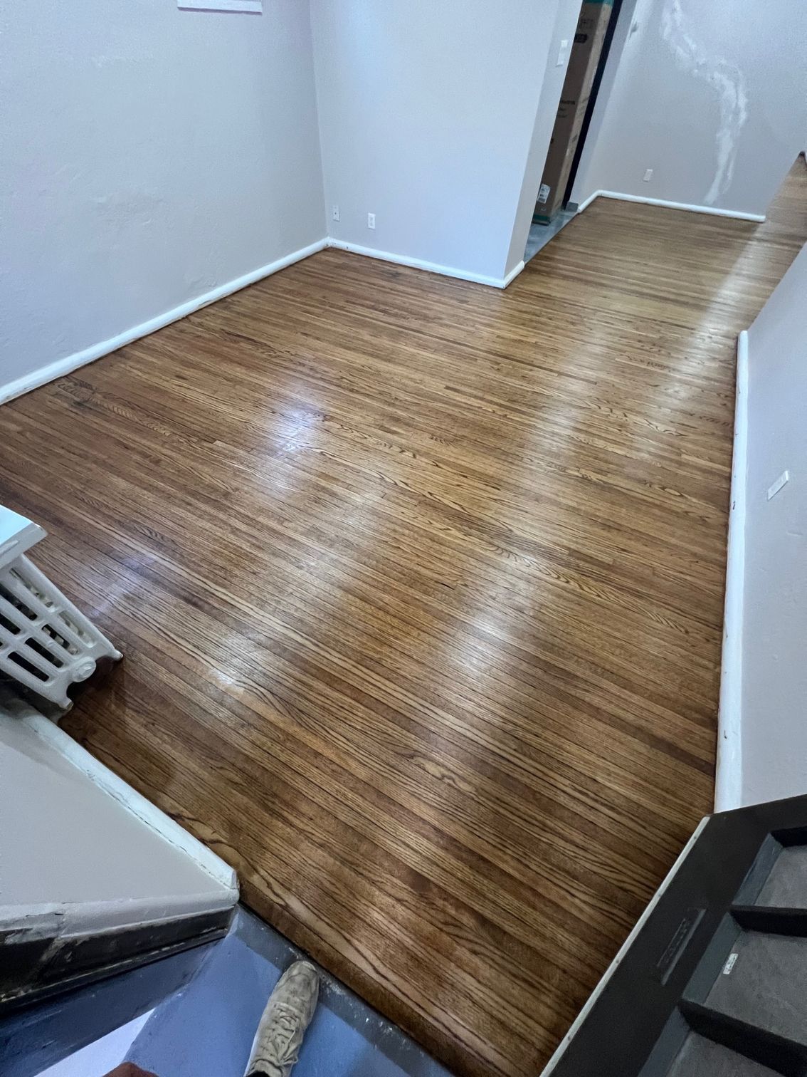 A room with a wooden floor and white walls.