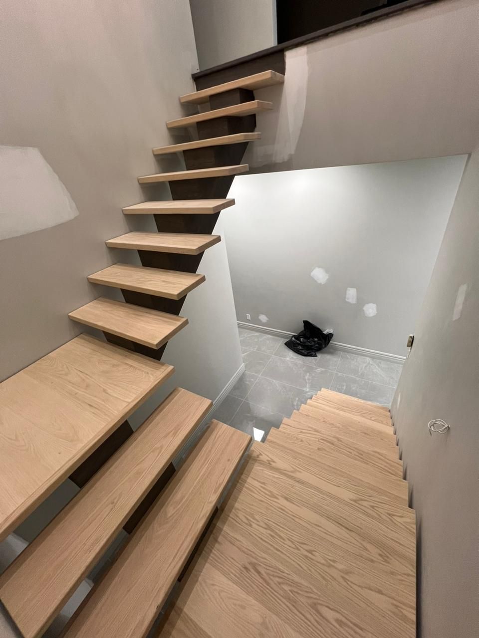 A wooden staircase leading up to the second floor of a house