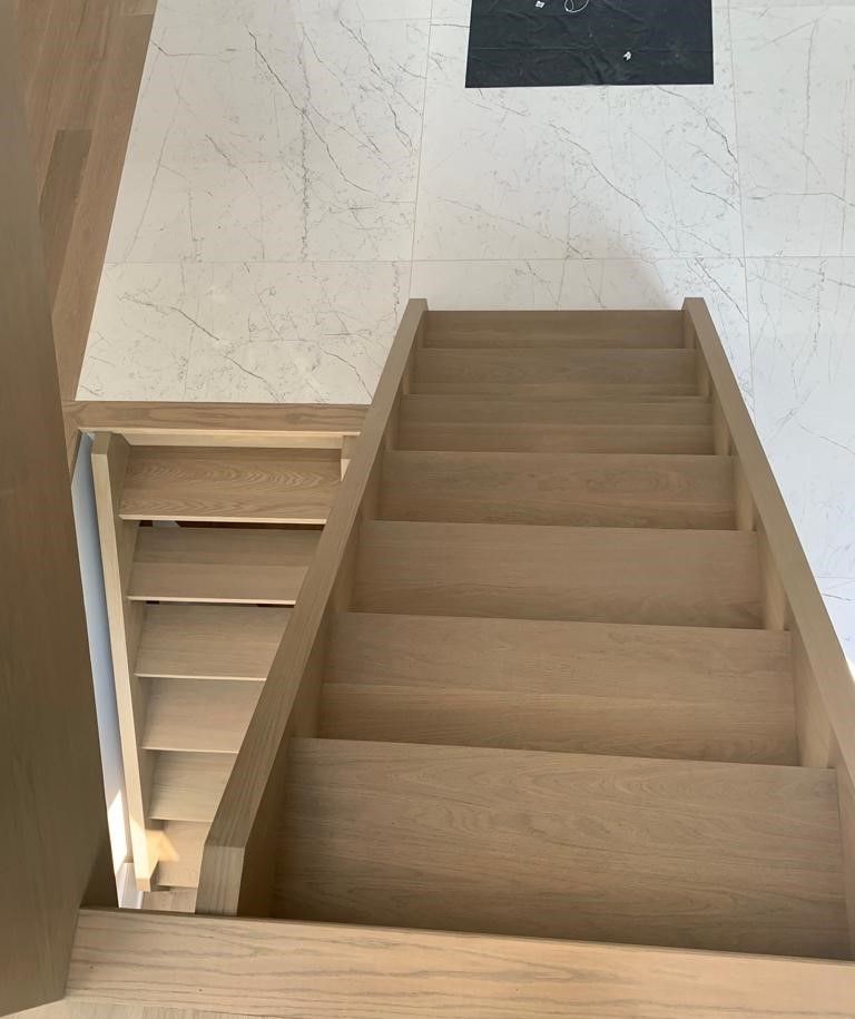 A wooden staircase leading up to the second floor of a house.