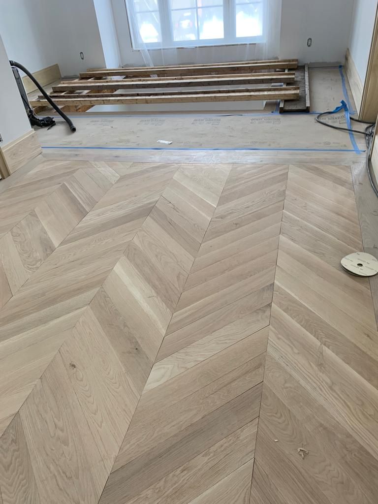 Hardwood Flooring with a chevron pattern in a room