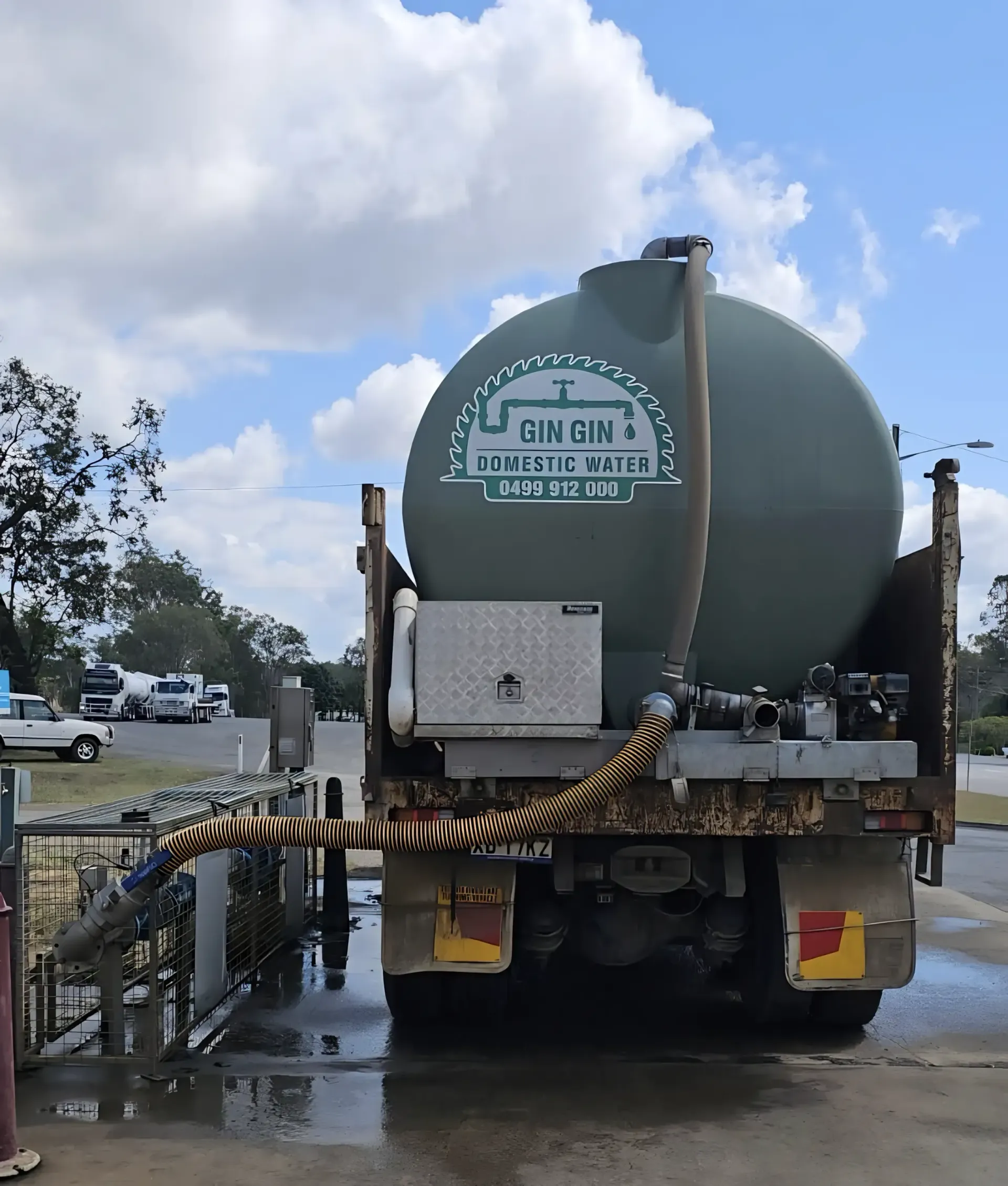 Green Water Tank in A Backyard — Gin Gin Domestic Water Supplies in South Kolan, QLD