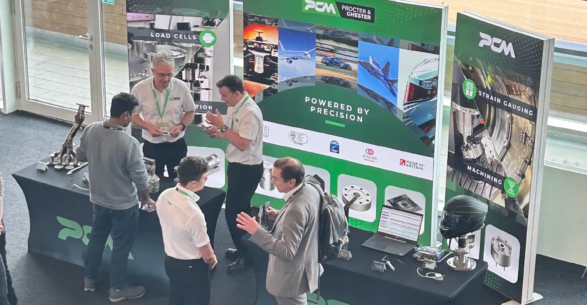 Members of PCM speaking with attendees of the instrumentation, analysis and testing exhibition.