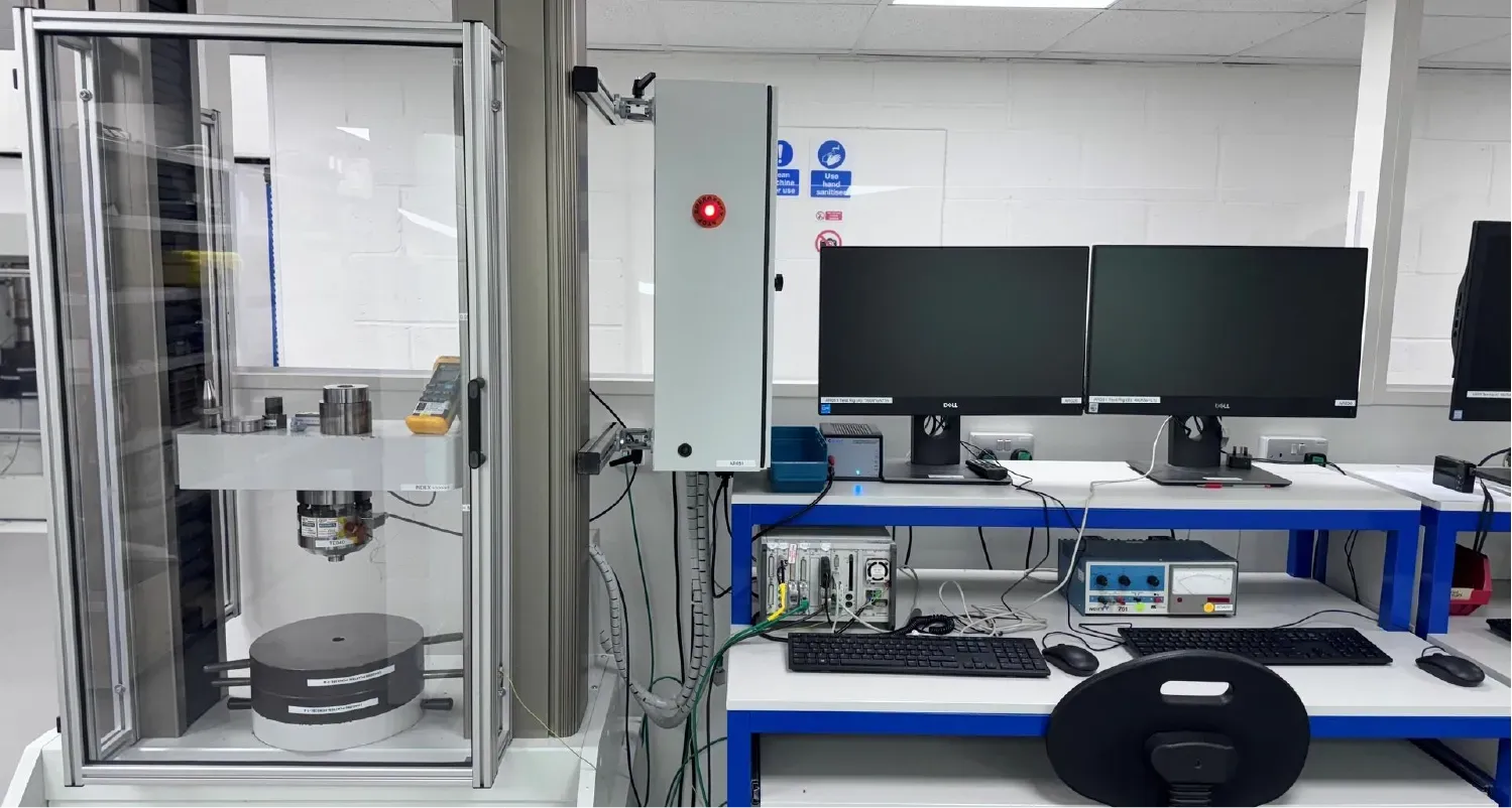 CNC machinist operating the Mazak machine, producing a load cell cover
