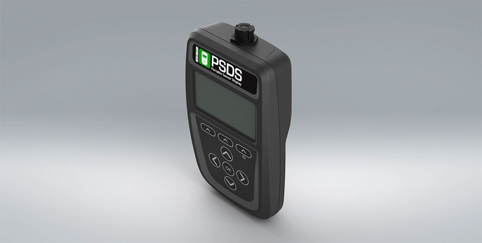 A black PSDS display device with a screen and touchpad of arrows and buttons.