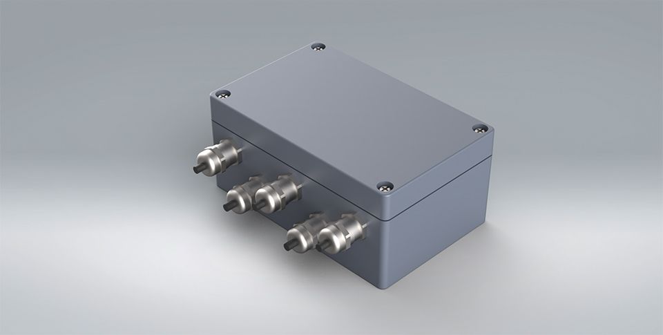 Dark grey metallic 3D Model of the SG4 load cell junction box on a lighter grey background.