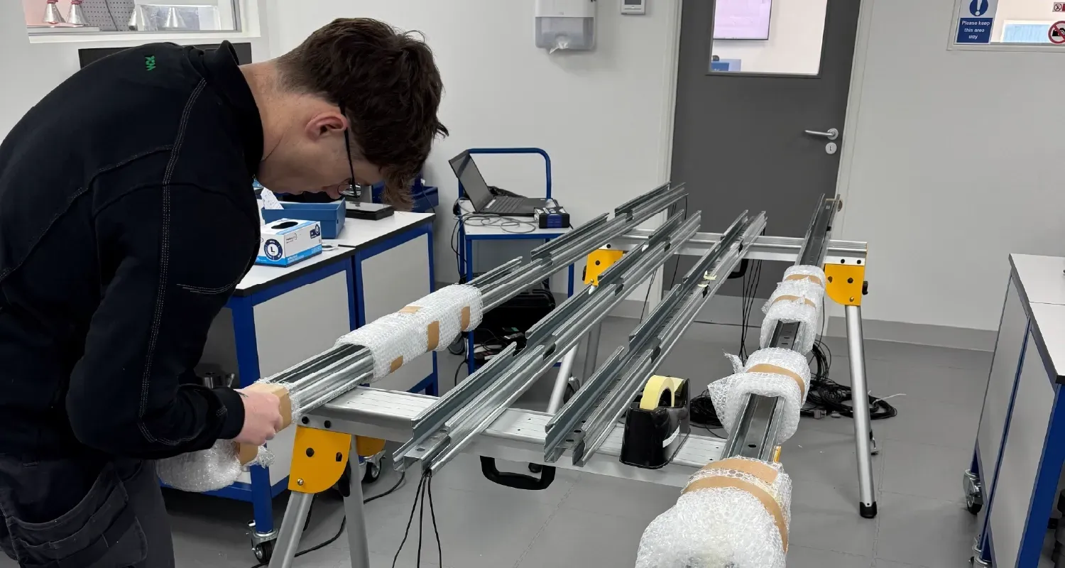 CNC machinist operating the Mazak machine, producing a load cell cover