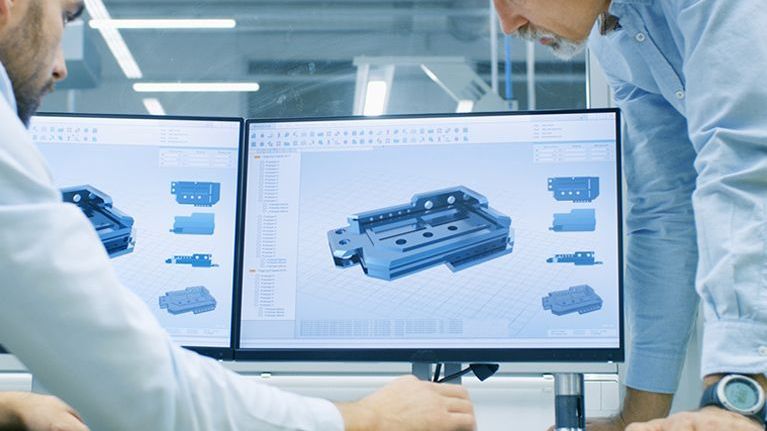 Two engineers at Procter and Chester designing a fully custom load cell on two computer screens.
