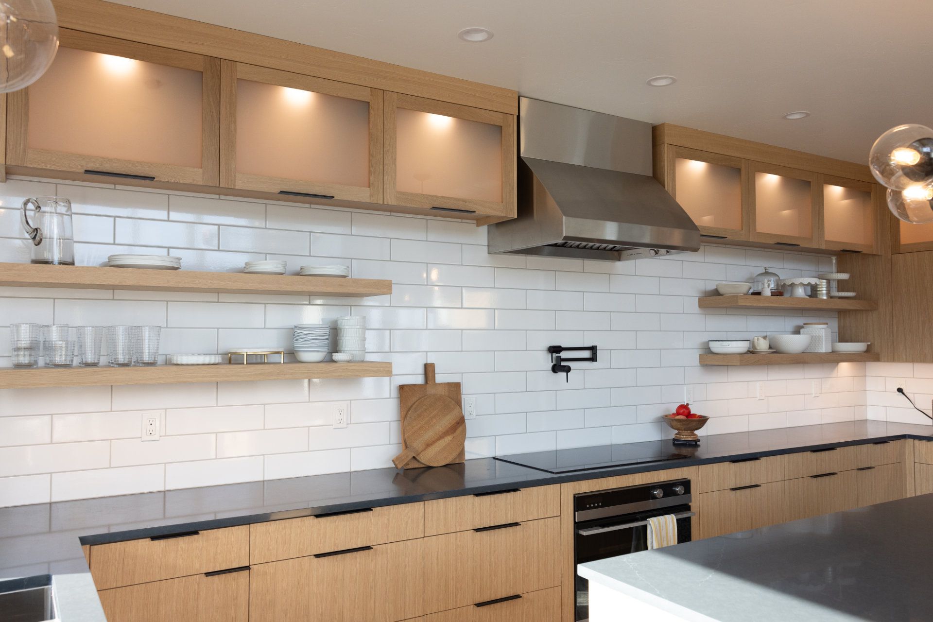A kitchen with stainless steel appliances and wooden cabinets.