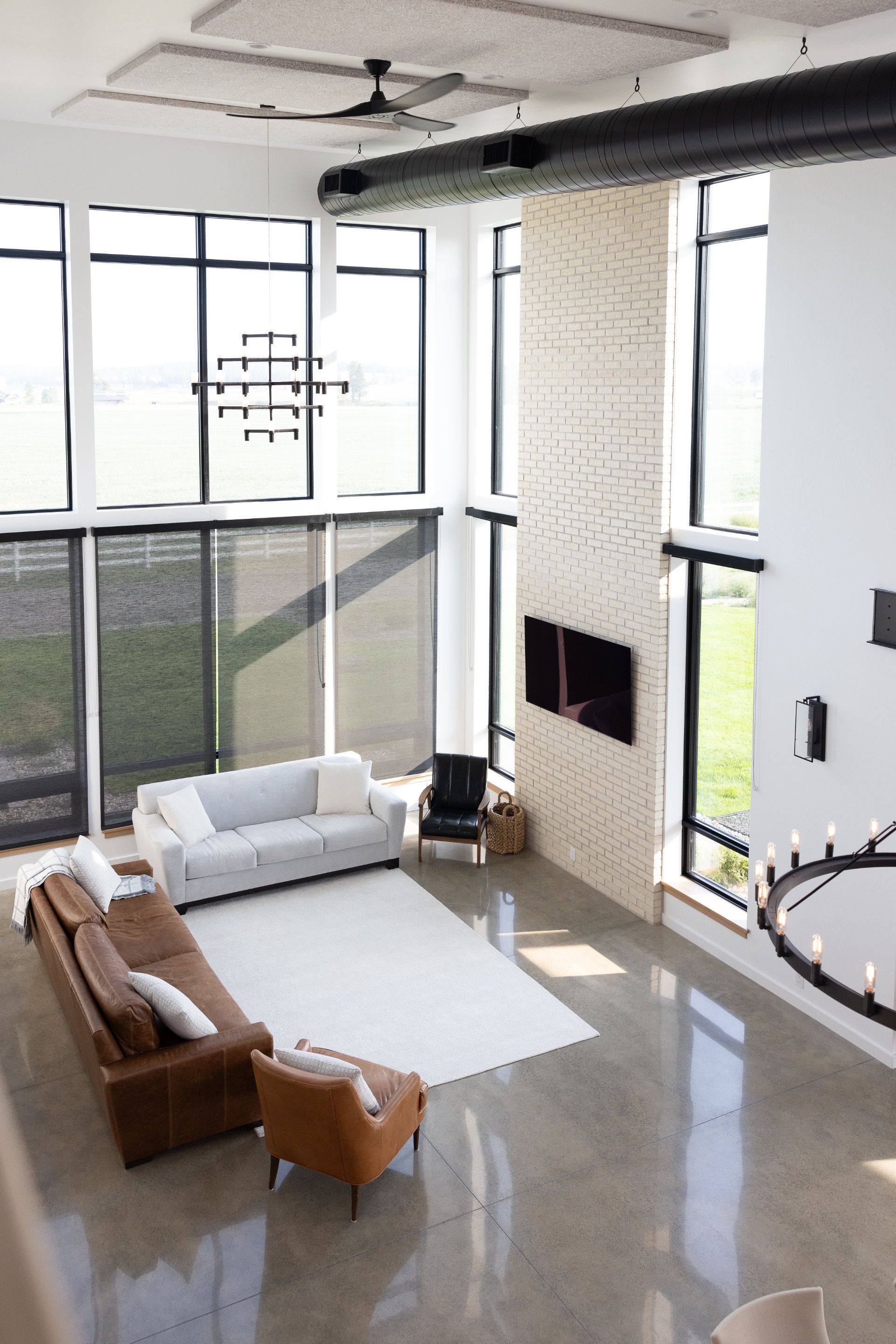 An aerial view of a living room with a couch and chairs.
