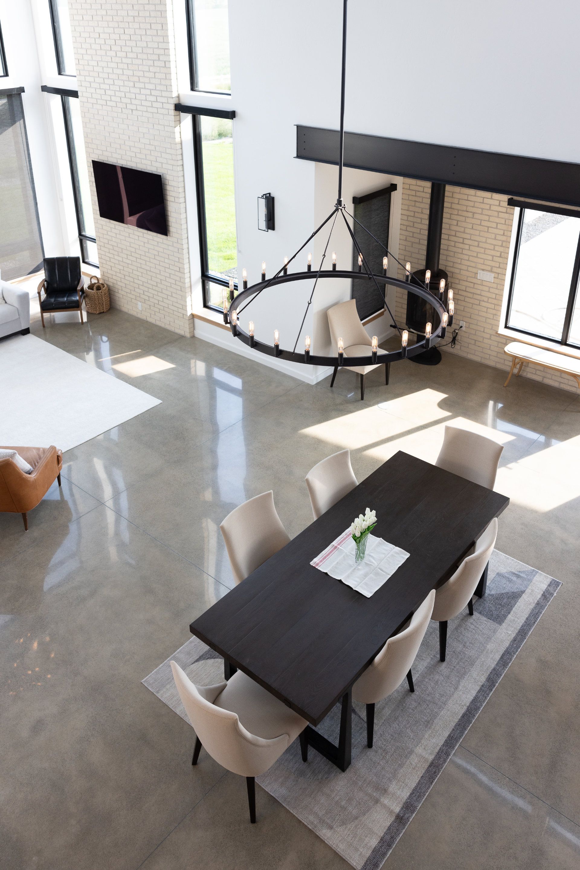An aerial view of a dining room with a table and chairs