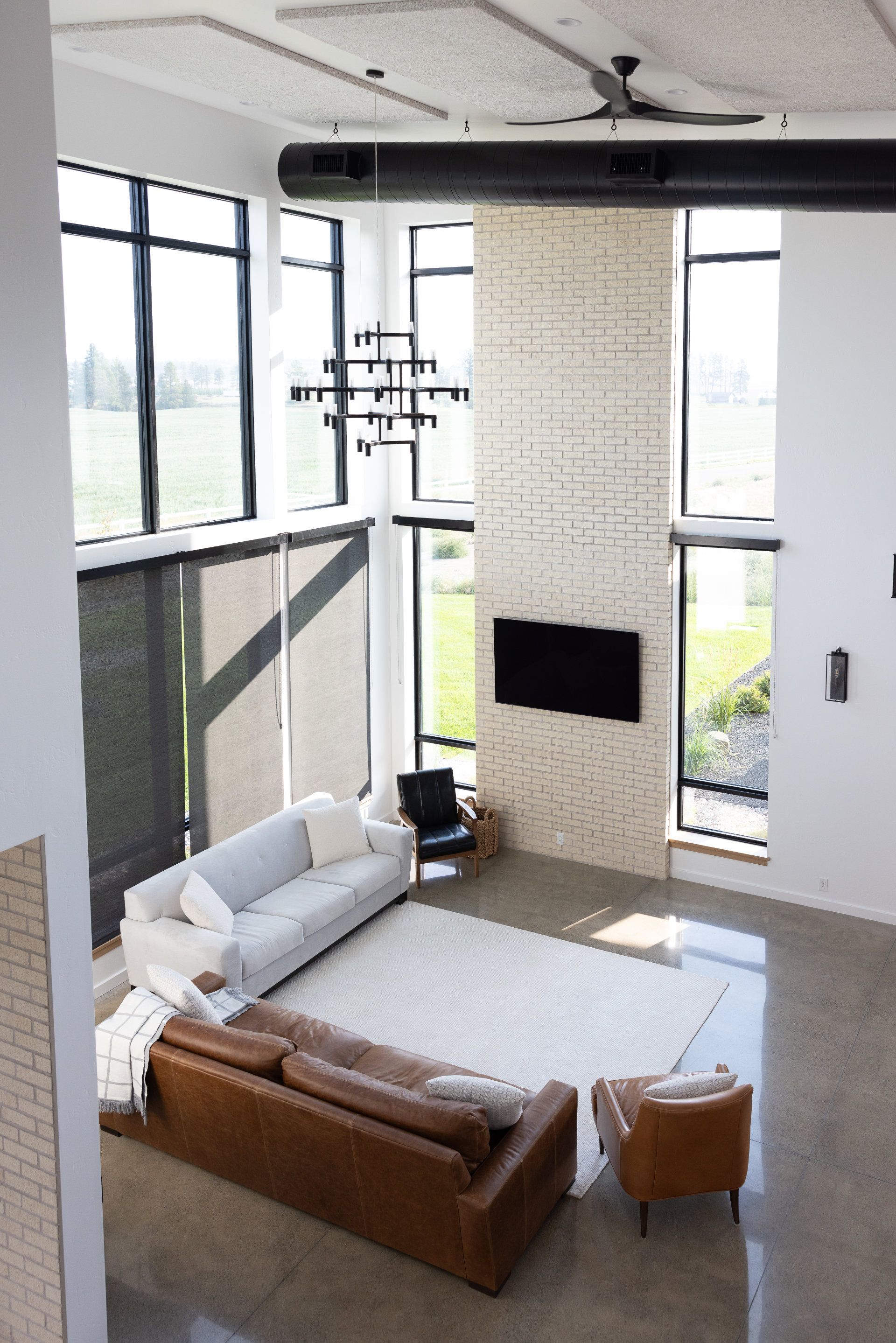 A living room with a couch and a television on the wall